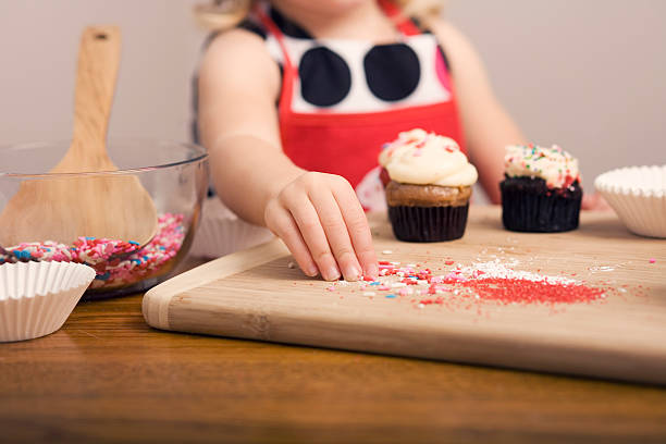 istock Cupcake Decorating by Little Girl Close Up Image 182051768