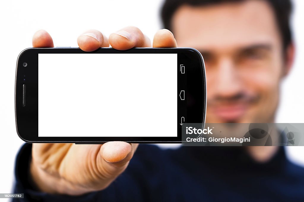 Uomo sorridente con grande schermo bianco Smartphone - Foto stock royalty-free di Adulto