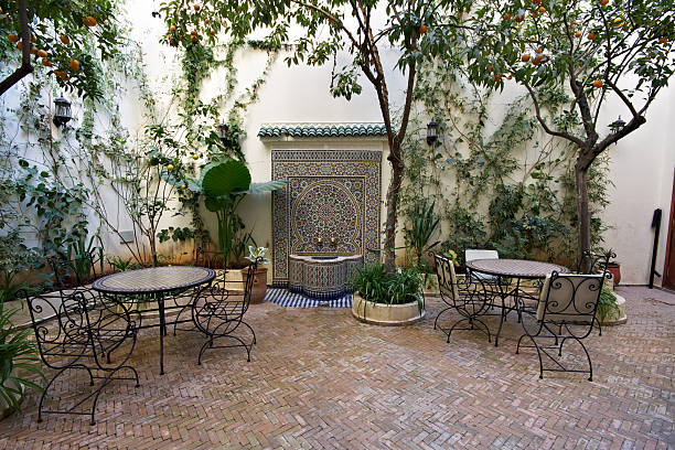 Courtyard Inside Old Riad in Fez, Morocco "Courtyard in old riad (traditional Moroccan house or palace) in Fez, Morocco with fountain" marrakesh riad stock pictures, royalty-free photos & images