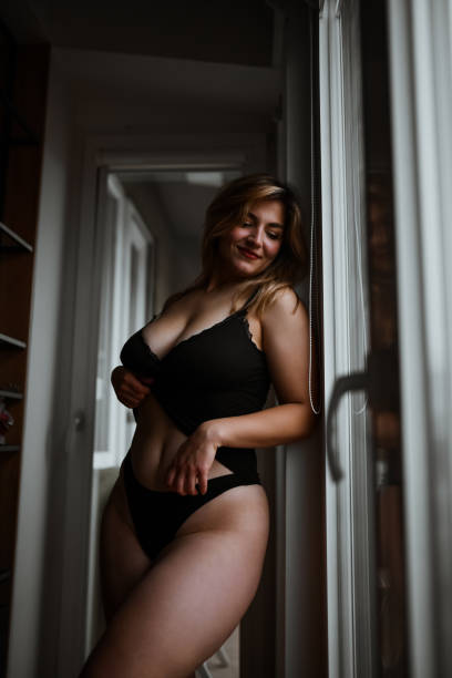 istock Gorgeous Plus Size Female Displaying Her Sensuality In Black Underwear 1820520354