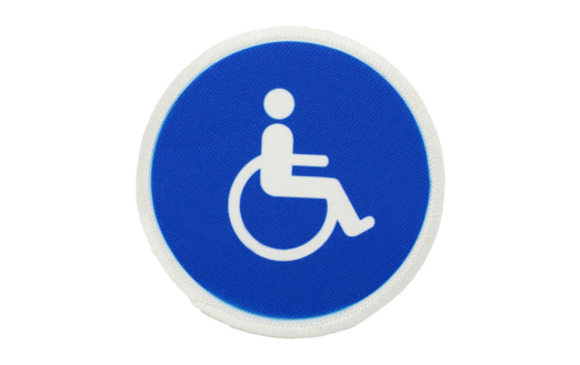 Isolated on white with clipping path.Universal handicapped and disabled symbol on a patch.