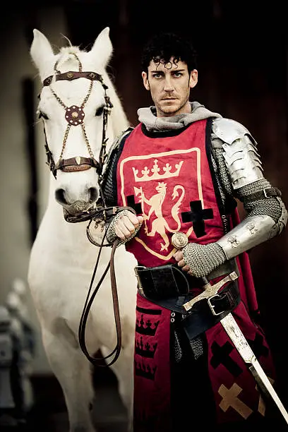 mystical portrait of  medieval Knight with beautiful white stallion, selective focus,hard lighting and very creative color retouching to underline the ancient medieval time,vignetting and possible noise,low key 