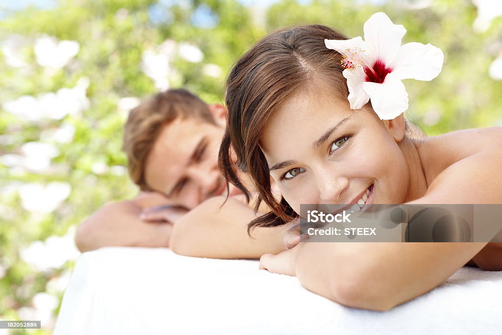 Enjoying being pampered together Beautiful young woman enjoying a spa day with her partner Adult Stock Photo