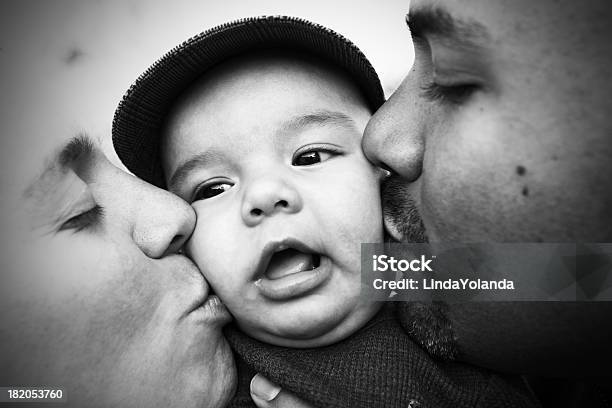 Mom And Dad Kissing Baby Stock Photo - Download Image Now - Black And White, Close-up, Multiracial Group