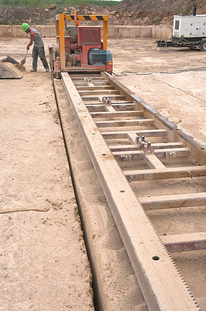 istock Workman shoveling limestone dust from saw blade's course 182053805