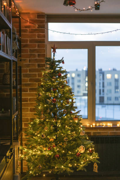 istock Christmas tree near the window  in apartment 1820539799