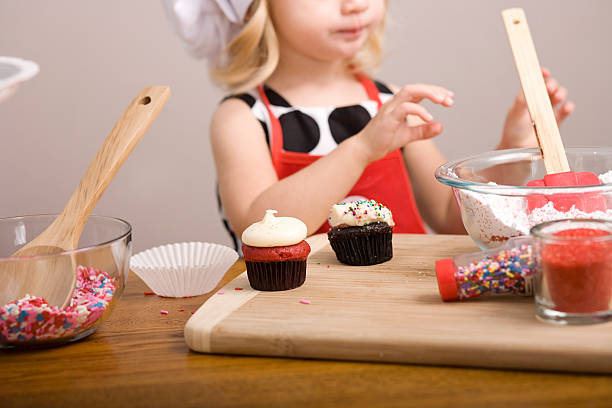 istock Cupcake Decorating by Little Girl Close Up Image 182054142