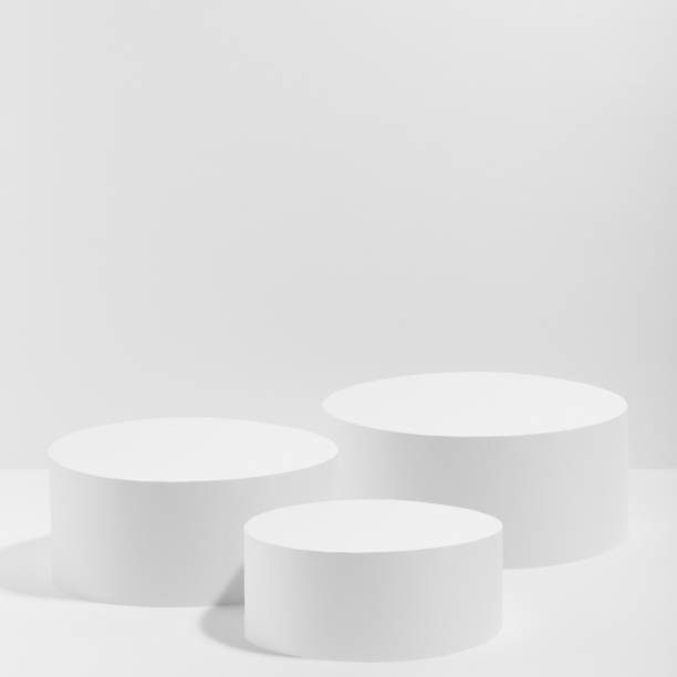 istock Abstract white stage with three white round podiums mockup for cosmetic products in hard light on white background. Scene for presentation cosmetic products, gifts, goods, advertising, design, sale. 1820545766