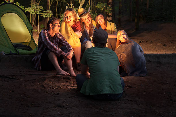 istock Group of Friends Sitting Around a  Campfire 182054612