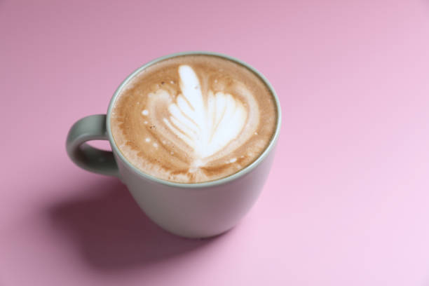 istock hot cappuccino with latte art isolated in pink background 1820547390
