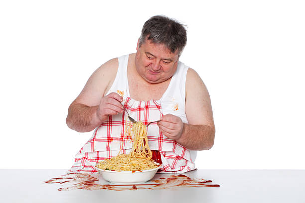 istock Happy fat man eating spagetti. 182054759