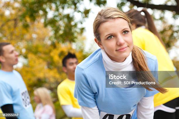 Teenage Girl Leaning Over At A Charity Race Stock Photo - Download Image Now - Running, Sports Race, Charity Benefit