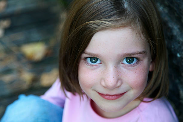 istock Beautiful Little Girl Smiling Looking Upwards 182055094