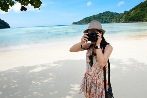 Cute photographer on the beach.