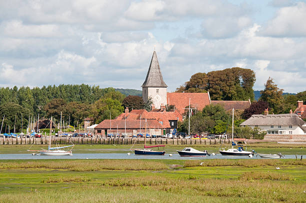 Old English Harbour "Bosham Church, harbour and village. An old English rustic setting" chichester stock pictures, royalty-free photos & images