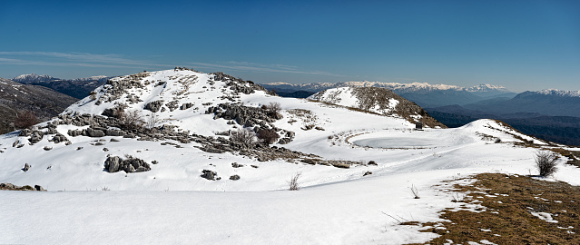 Panoramic winter landscape with frozen lake at Mount Avgerinos in Epirus, Greece