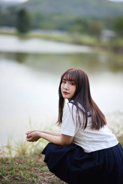Japanese high school student looking on countryside background