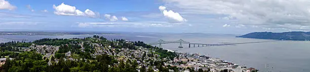 Panoramic of beautiful Astoria Oregon with the Columbia river and the Pacific Ocean in the background. Passing over the bar to the get to  ocean is the most dangerous in the world. Photo taken from atop of the Astoria Column.The bridge crosses over to Washington State from Oregon.This is an exceptional clear day to be able to see this far.