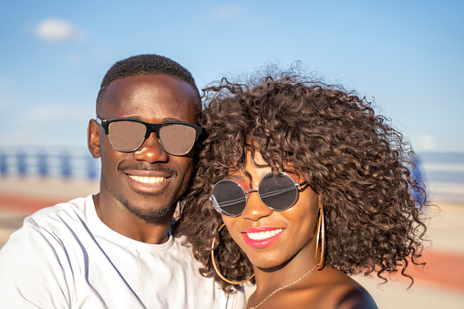 Black skinned couple smiling at camera