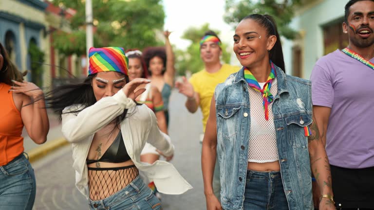 LGBTQIA+ friends dancing and walking on the street