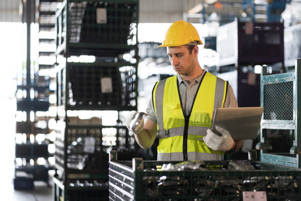 istock Storage warehouse and manufacturing concept. Male warehouse worker working with laptop computer and inspecting quality for auto spare parts at warehouse 1820570739