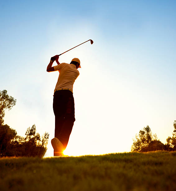istock Golfer swinging at beautiful sunset 182058095