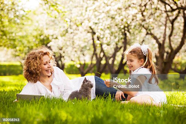 Madre E Hija Jugando Con Mascota En El Parque En Prado Foto de stock y más banco de imágenes de Gato doméstico