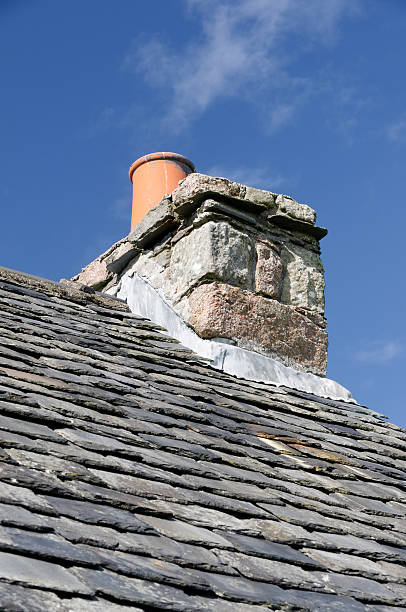 istock Chimney on an old slate roof 182058503
