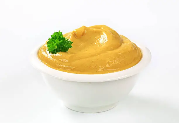 spicy mustard in a small white bowl