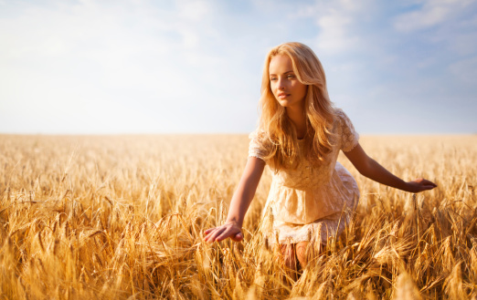 Beautiful blond girl at the wheat field