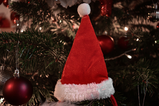 A red Santa Claus hat Christmas tree decoration
