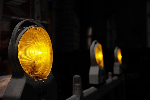 Yellow lights at a construction site with focus on the foreground