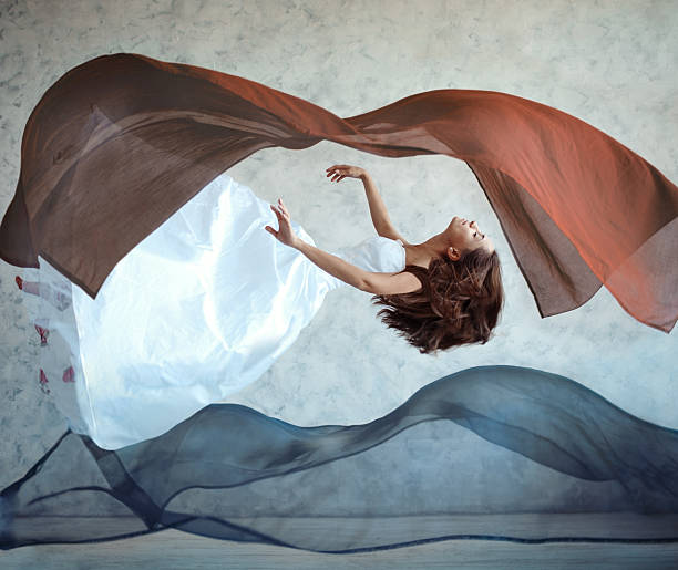 Flying woman Surreal woman flying zero gravity stock pictures, royalty-free photos & images