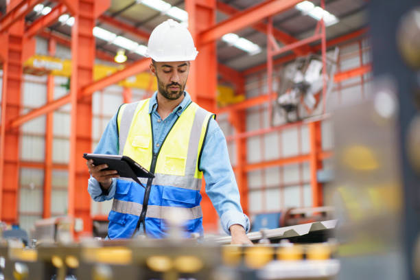 istock Engineer inspecting machines in factory. 1820597316