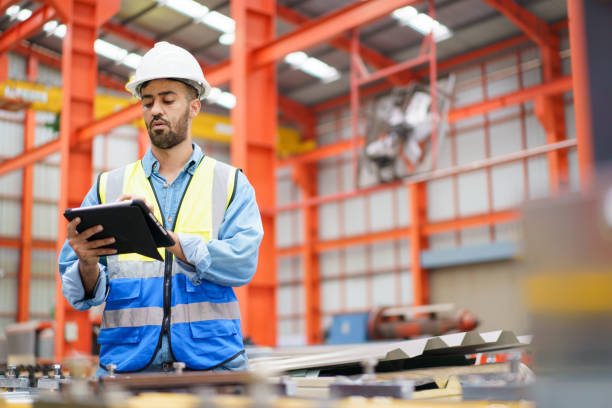 istock Engineer inspecting machines in factory. 1820597327