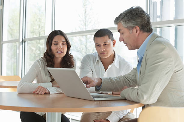 istock Man Explaining an Investment Plan To Couple 182059834