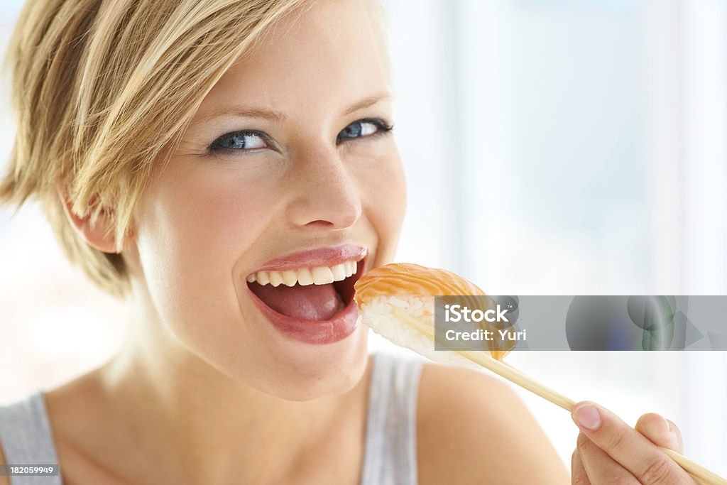 Mmmmmm Nigiri my favourite - Sushi Pretty young woman about to have a bite of a Sushi Nigiri Women Stock Photo