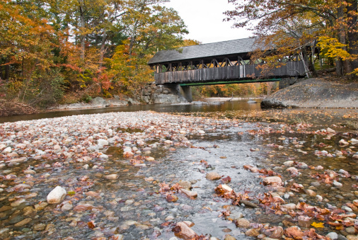 Old covered bridge in New England during autumn.