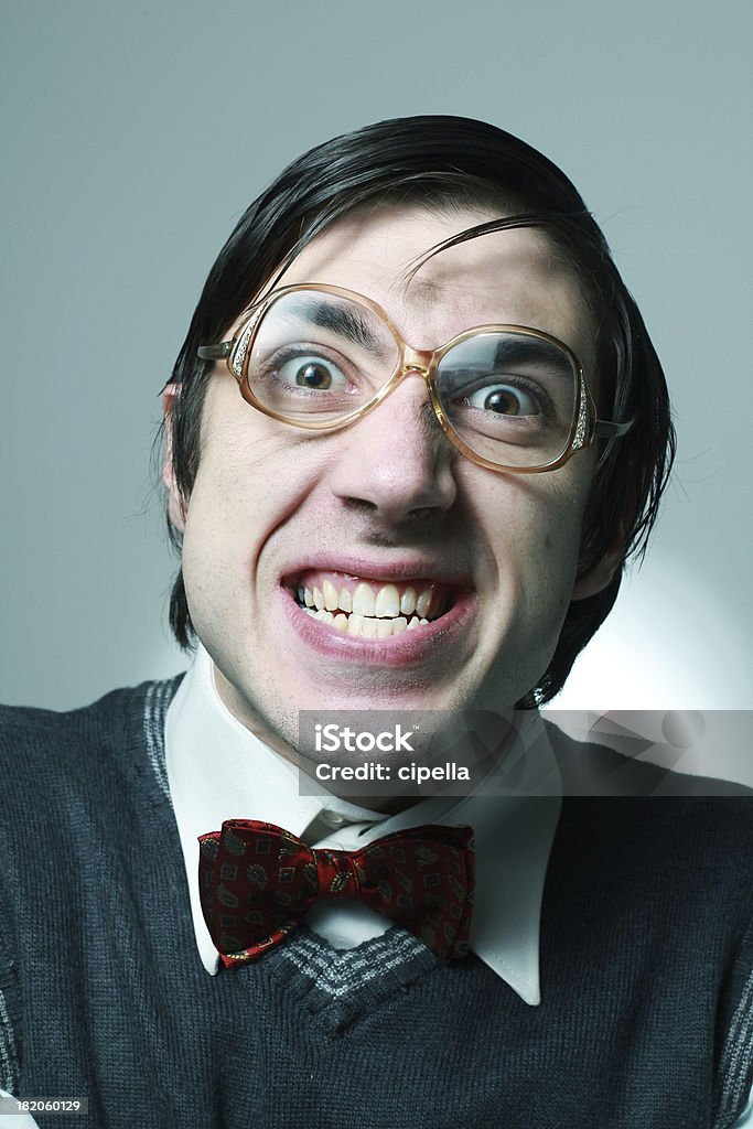 Nerd Portrait of nerd student with retro glasses showing his teeth Anger Stock Photo