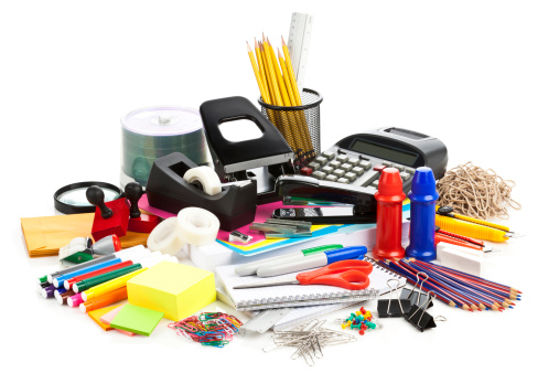 Large assortment of office supplies on white backdrop