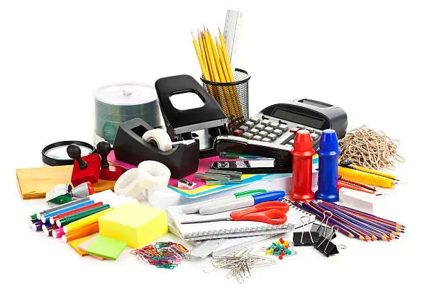 Photo of Large assortment of office supplies on white backdrop