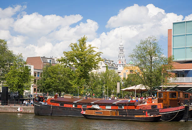 istock Amsterdam canal scene with boat 182060367