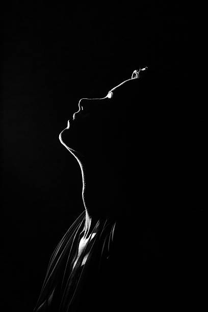 Old Hollywood.Her silhouette "Emulation of vintage style photography,Female silhouette against the black background. See the Lightbox:" fine art portrait photos stock pictures, royalty-free photos & images