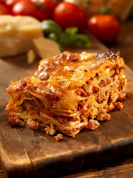 Authentic Italian Meat Lasagna on a Cutting Board with Ingredients -Photographed on Hasselblad H3D2-39mb Camera