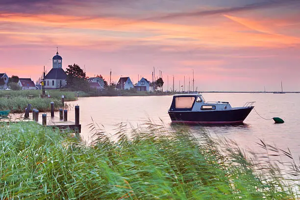A typical Dutch coastal village at sunrise. Photographed in Durgerdam, just north of Amsterdam. A seamlessly stitched panoramic image.