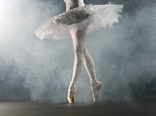 Ballerina in tip on stage "Young female ballerina standing on toes, low section" ballet dancer feet stock pictures, royalty-free photos & images