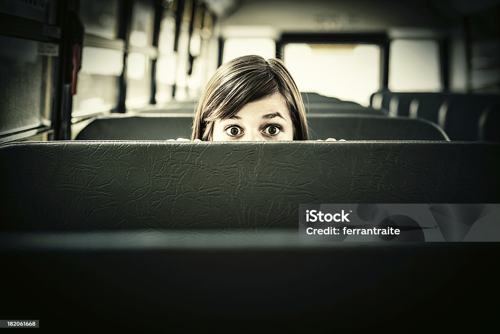 Scared Student in School bus Terrified Student hiding in School bus Bus Stock Photo