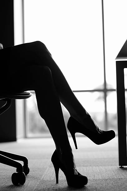 istock Crossed legs with high heels in the office 182061741