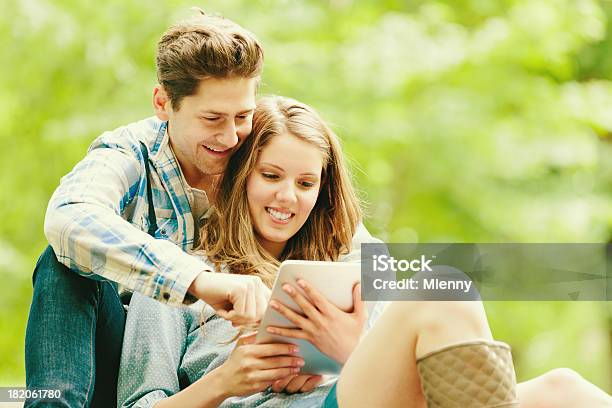 Couple In Green Nature With Tablet Pc Modern Technology Stock Photo - Download Image Now