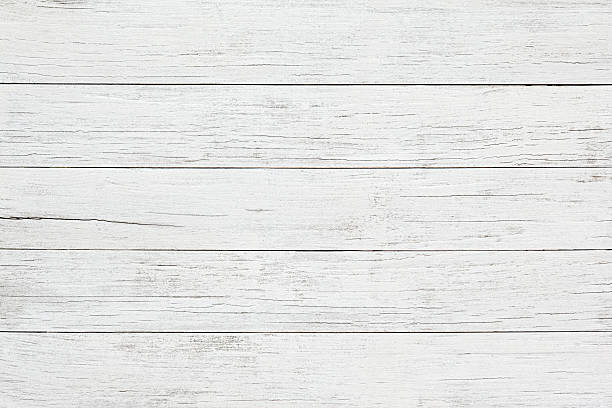 White wooden board background A group of five boards are arranged horizontally across the image.  They have faded, flaking white paint across them, and there are gaps between each board.  All of the boards show cracks and splits in them, and they have an extremely weathered appearance. rustic stock pictures, royalty-free photos & images